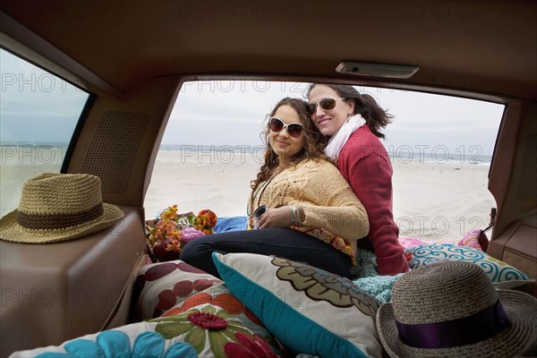 Caucasian mother and daughter posing in car