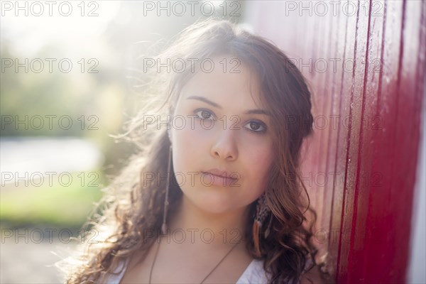 Serious Caucasian woman leaning on wall