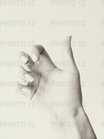 Close up of curled fingers on hand of woman