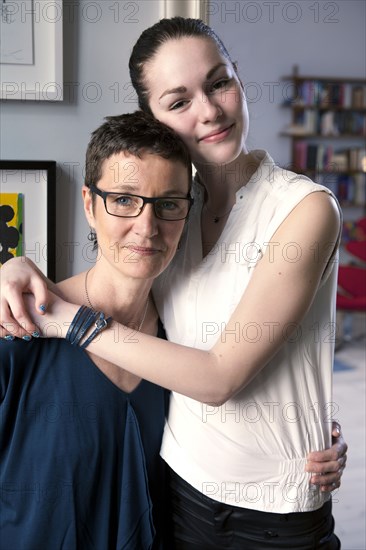 Caucasian mother and daughter hugging