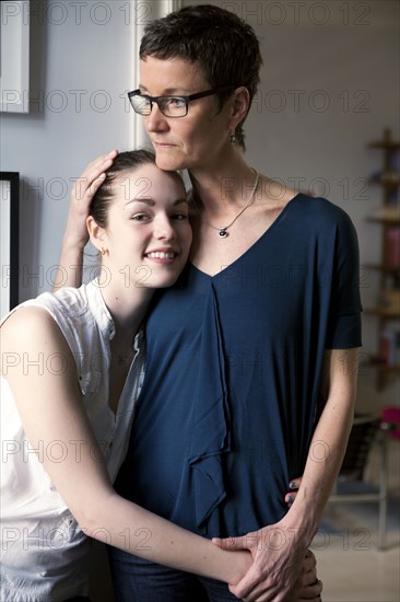 Caucasian mother and daughter hugging