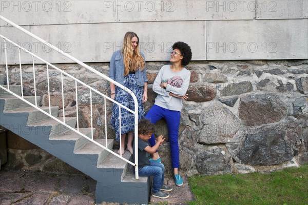 Teenagers and boy standing on steps