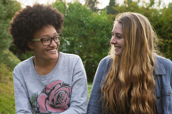 Teenage girls smiling in backyard