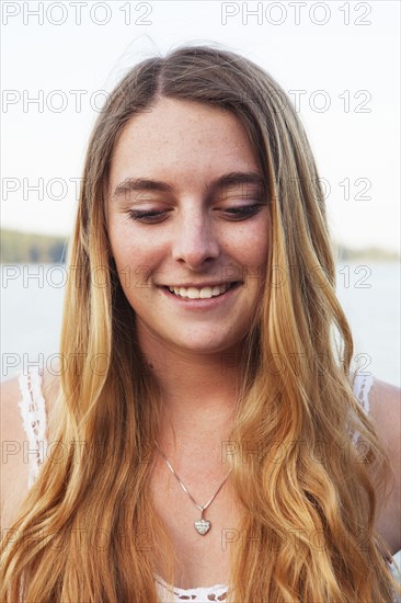 Smiling Caucasian teenage girl looking down