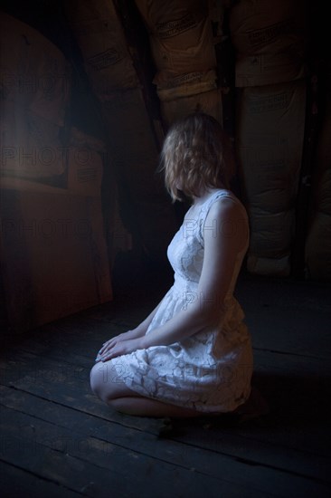 Lonely Caucasian woman sitting on floor