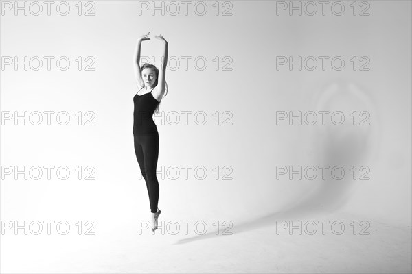 Caucasian dancer jumping for joy