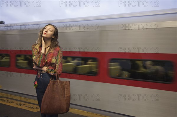 Woman missing passing train in train station