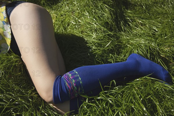 Woman in knee socks laying in grass