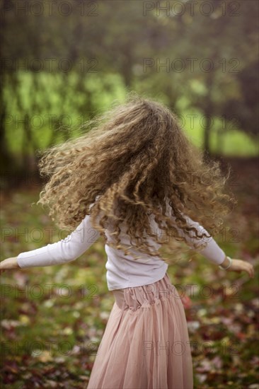 Caucasian girl playing in autumn leaves