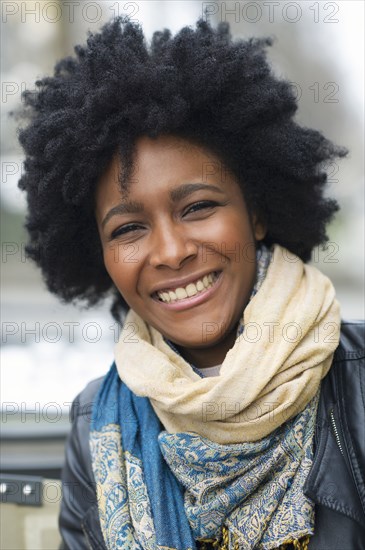 Smiling Black woman wearing scarves