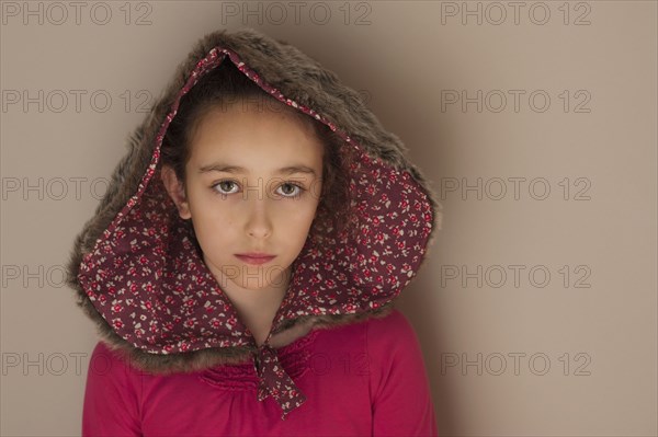 Sad Caucasian girl wearing hood