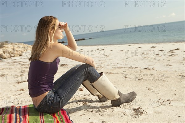 Woman admiring ocean view from beach