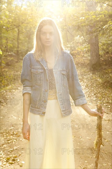 Woman walking on dirt path in forest