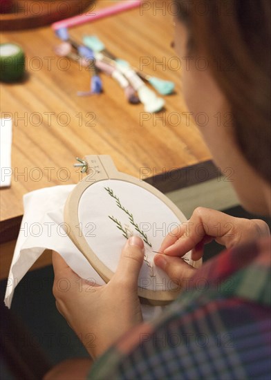 Close up of woman hand-stitching embroidery