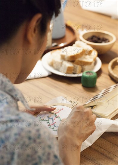 Close up of woman hand-stitching embroidery