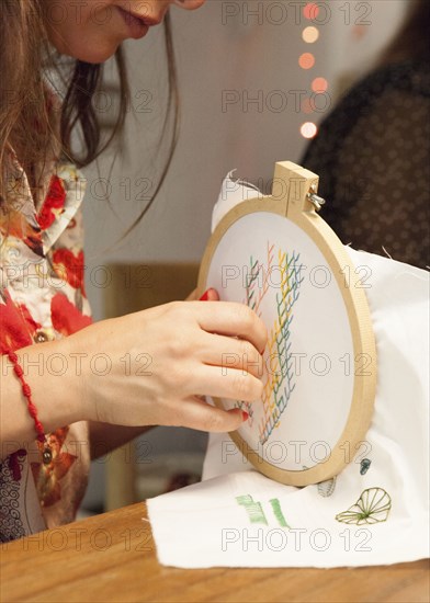 Close up of woman hand-stitching embroidery