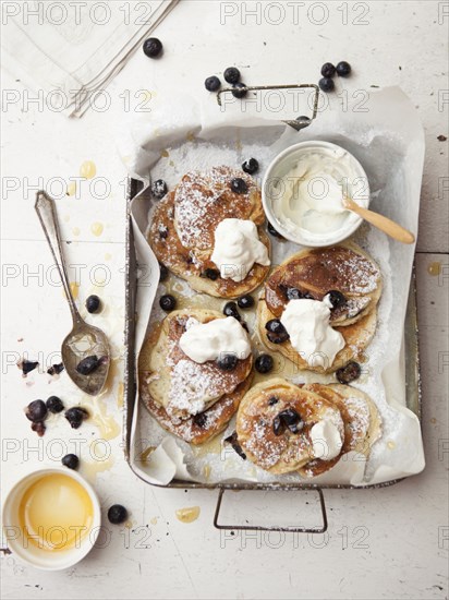 Tray of pancakes with fruit and cream