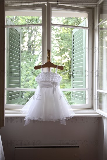 Formal dress hanging in window
