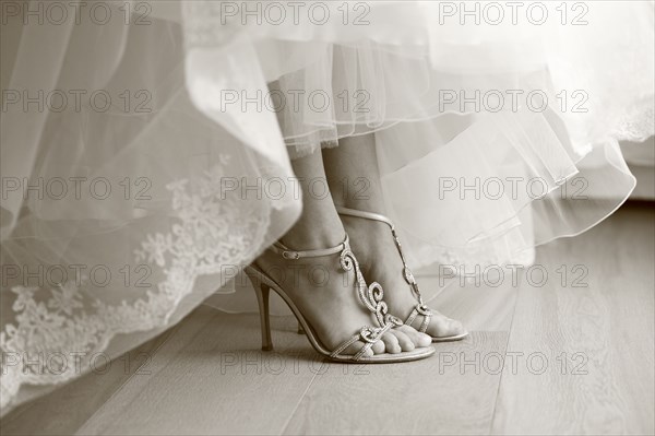 Close up of feet of bride in wedding shoes