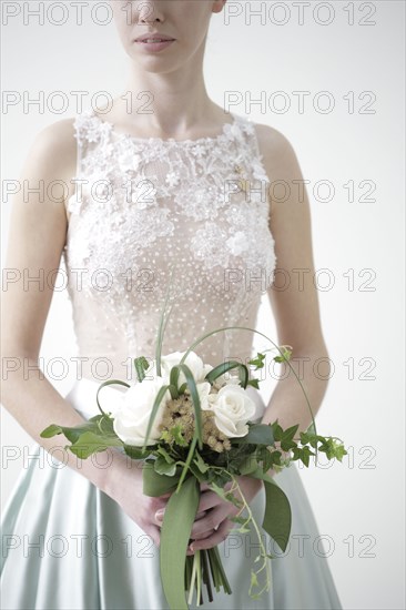 Bride carrying bouquet of flowers