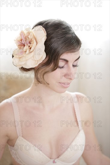 Caucasian woman wearing flower in her hair