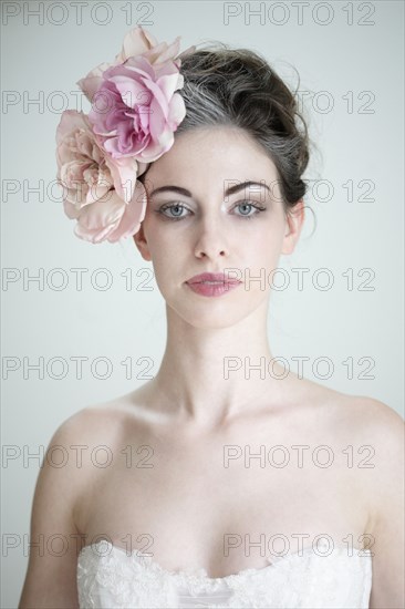 Caucasian bride wearing flower in hair