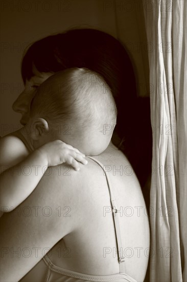 Caucasian mother holding crying baby