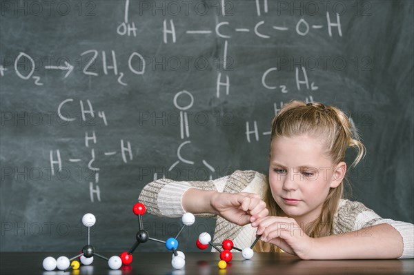 Caucasian student building molecular model in science class