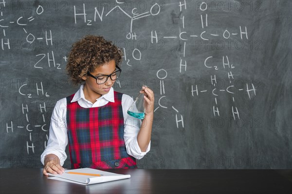 Mixed race student doing experiment in science class