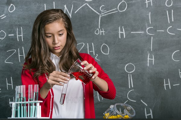 Hispanic student doing experiment in science class