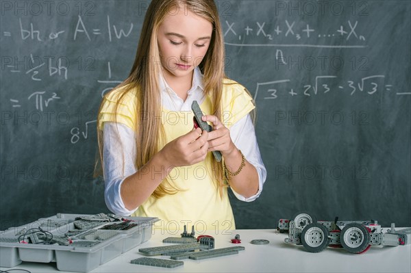 Student building vehicle in science class