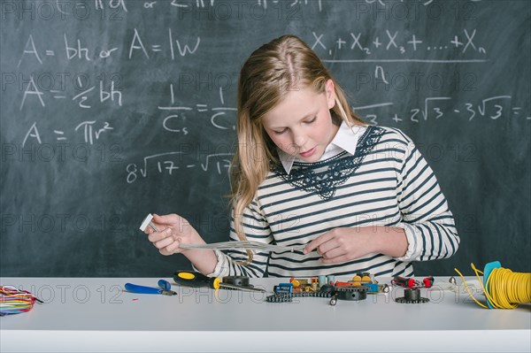 Student building vehicle in science class