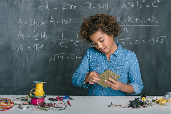 Mixed race student building vehicle in science class