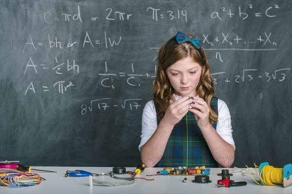 Caucasian student building vehicle in science class