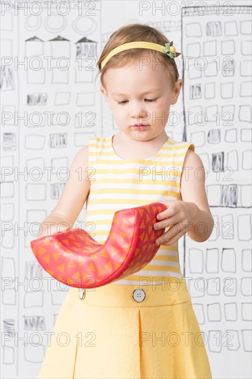 Close up of girl examining toy