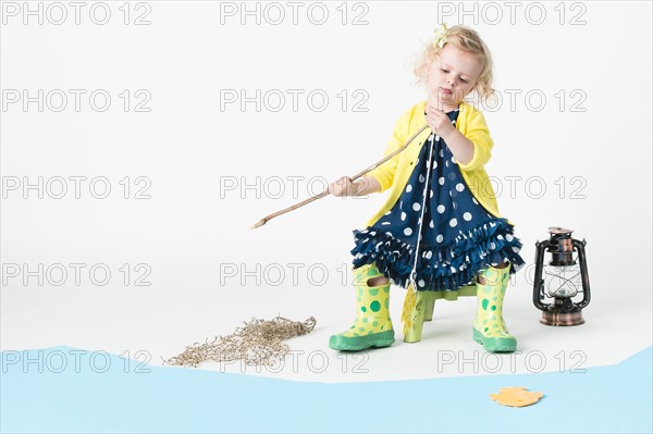 Girl playing fishing with toy fish