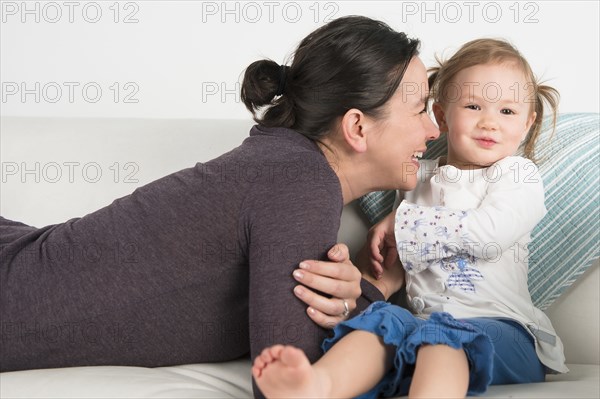 Smiling mother nuzzling daughter