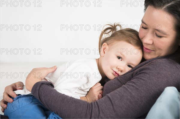 Close up of mother and daughter cuddling