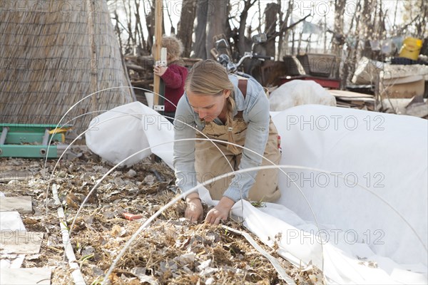 Mother and son working in autumn garden