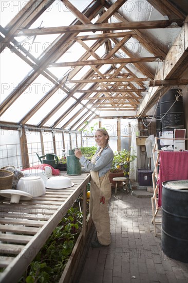 Gardener working in greenhouse