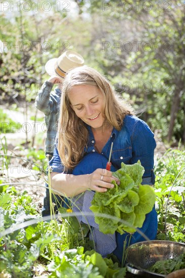 Mother and child gardening in backyard