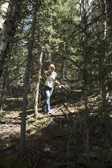 Woman walking on forested hillside