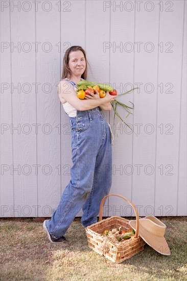 Mixed race farmer with basket of vegetables
