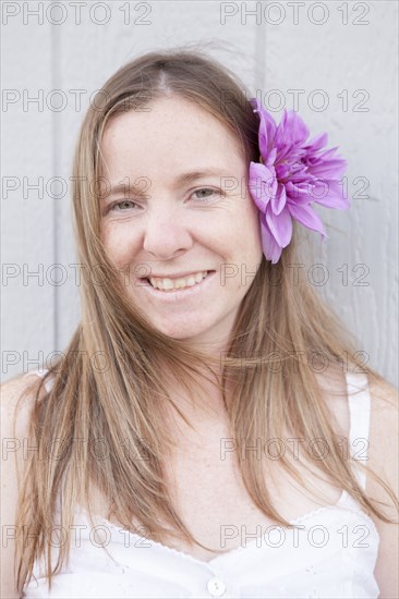 Mixed race woman wearing flower in her hair