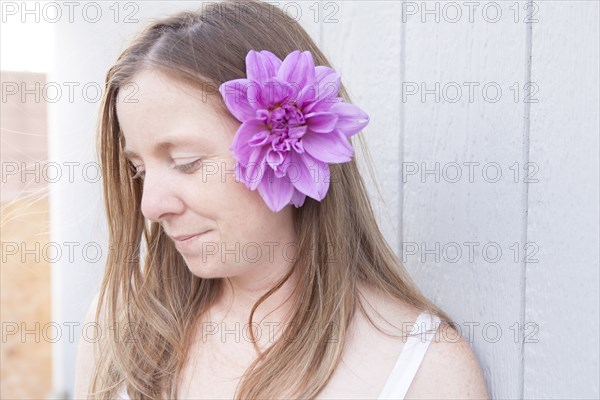 Mixed race woman wearing flower in her hair