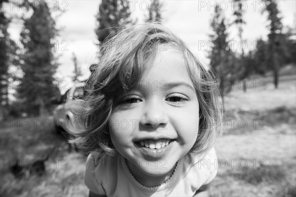 Close up of smiling Caucasian girl on hillside