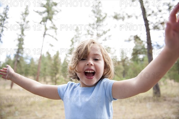 Close up of smiling Caucasian girl in forest