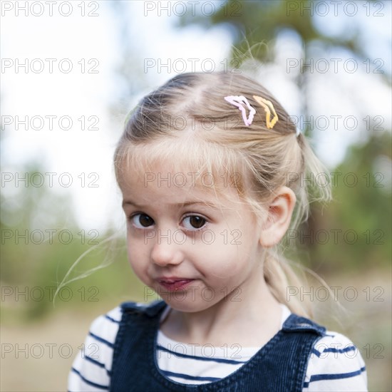 Close up of serious Caucasian girl on hillside