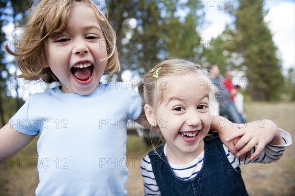 Close up of Caucasian sisters hugging outdoors