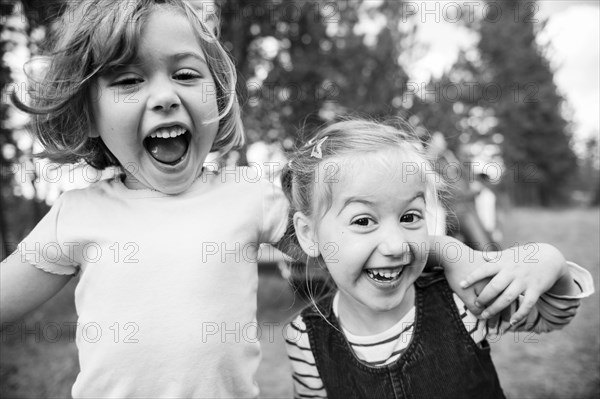 Close up of Caucasian sisters hugging outdoors